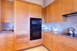 The kitchen features custom cabinets, Sub Zero frig/freezer, custom tile and granite